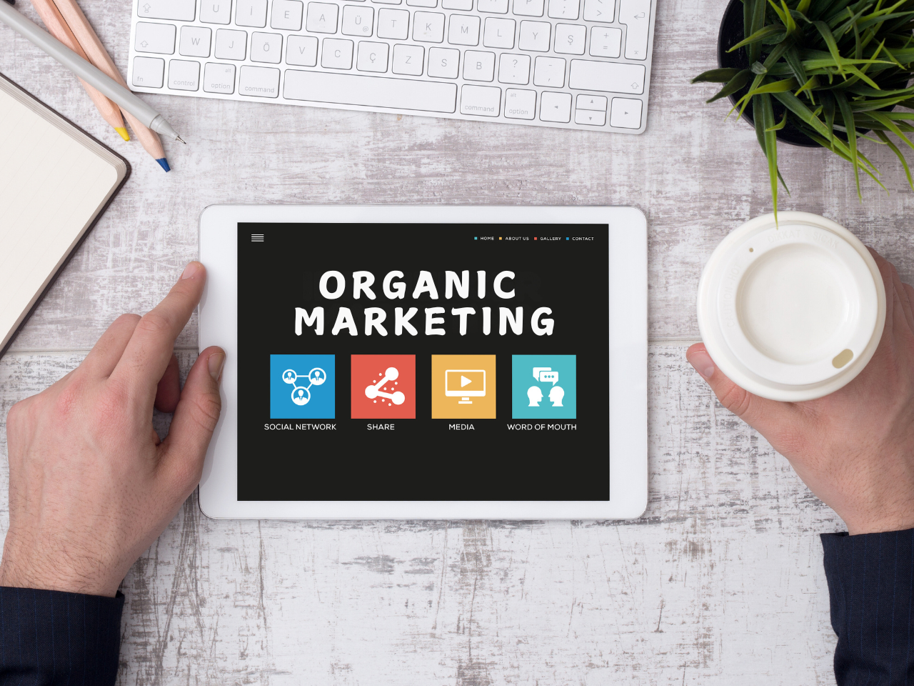 A picture showing a tablet on the table with the word organic marketing on top