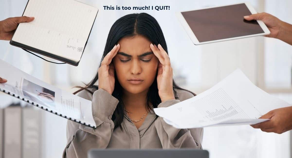 a woman with her hands on her temples feeling overwhelemed by too much work